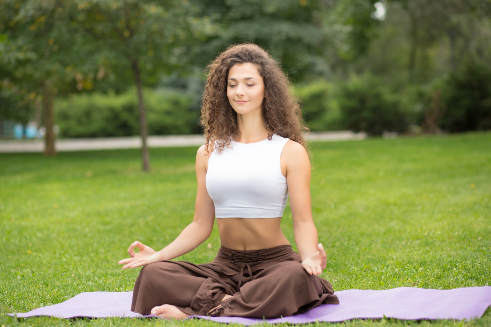 Pretty woman doing yoga exercises