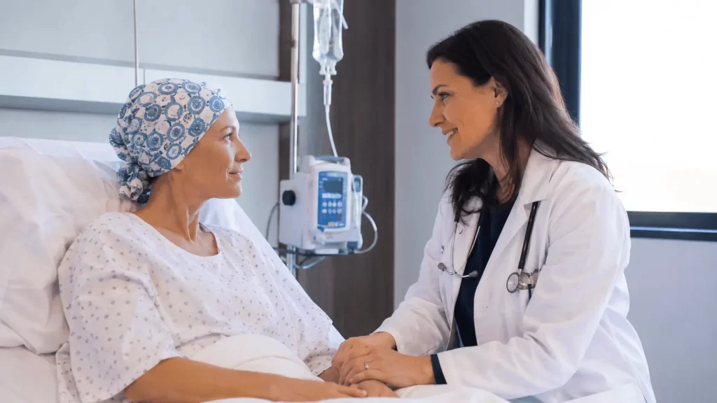 Doctor providing compassionate care to a bone marrow transplant patient during recovery in a modern hospital room.